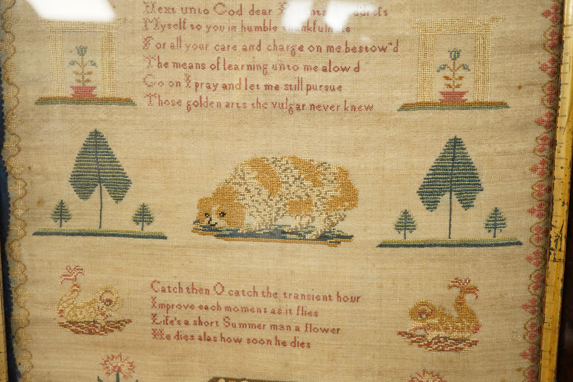 An early 19th century framed sampler by Sarah Crowhurst aged 10 years, dated 1811. Very finely embroidered, on fine linen, with a line of alphabet, then a religious verse and a large central spaniel motif between stylist
